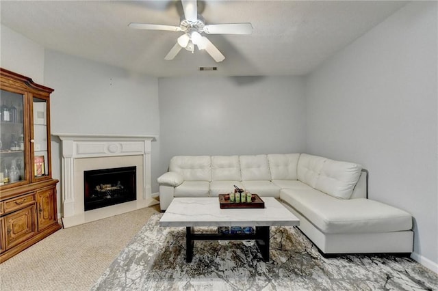 carpeted living room with ceiling fan