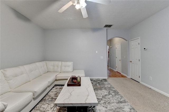 living room with ceiling fan and light colored carpet