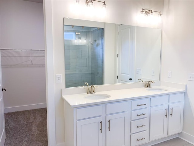 bathroom with a shower with door and vanity