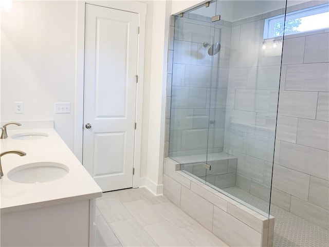 bathroom with tile patterned flooring, a shower with door, and vanity