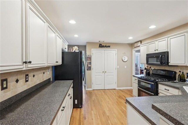 kitchen with black appliances, dark countertops, light wood-style floors, tasteful backsplash, and recessed lighting