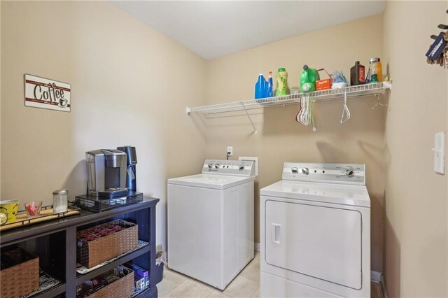 laundry area featuring washing machine and dryer and light tile patterned flooring