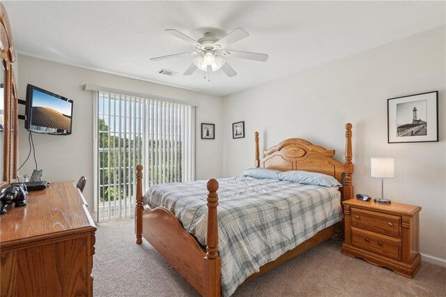 bedroom featuring light colored carpet, access to exterior, a ceiling fan, and baseboards