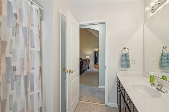 bathroom with tile patterned floors, vanity, a shower with shower curtain, and baseboards