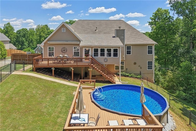view of swimming pool featuring a wooden deck and stairway