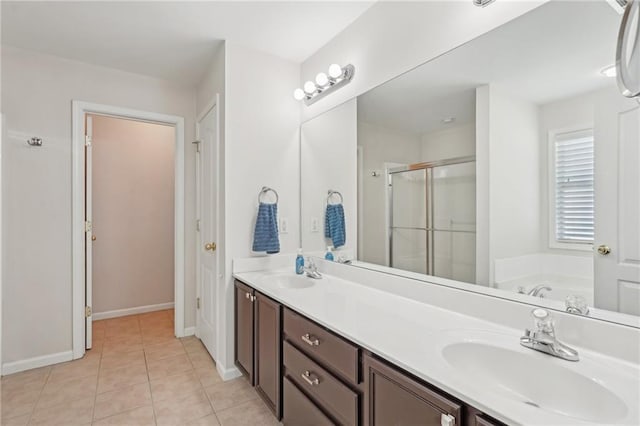full bath with a stall shower, a bath, tile patterned floors, baseboards, and double vanity