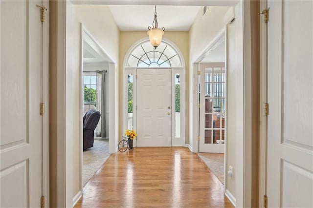 entryway featuring light wood-type flooring and baseboards