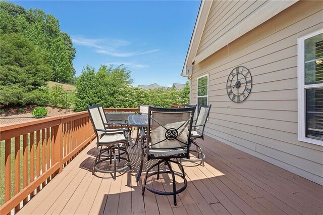 deck with outdoor dining area
