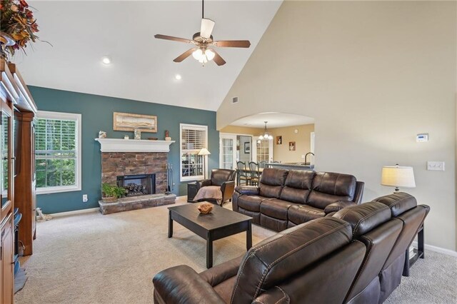 living area featuring arched walkways, carpet floors, ceiling fan, baseboards, and high vaulted ceiling