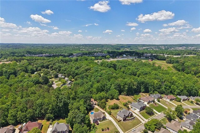 aerial view of residential area with a heavily wooded area