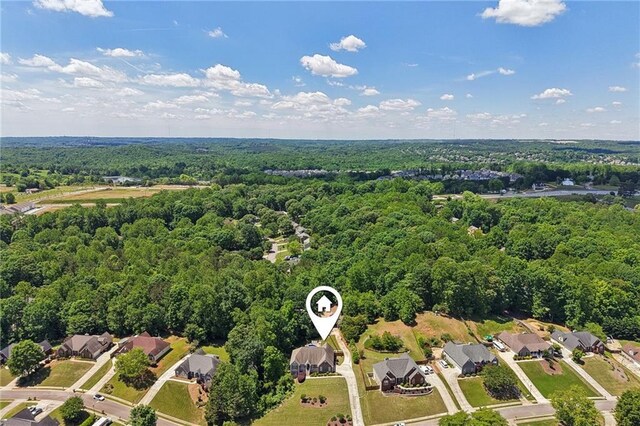 aerial view of residential area with a heavily wooded area