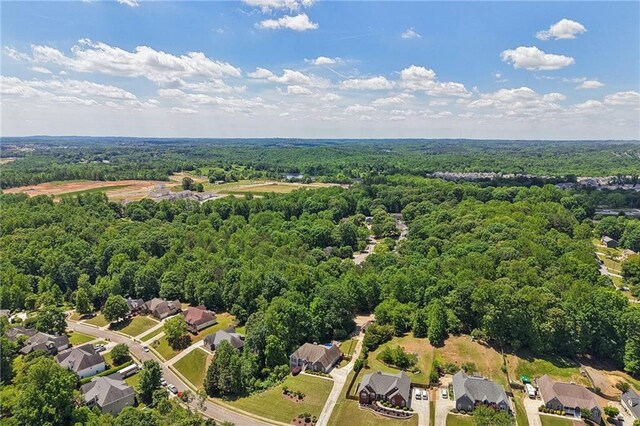 aerial perspective of suburban area featuring a heavily wooded area