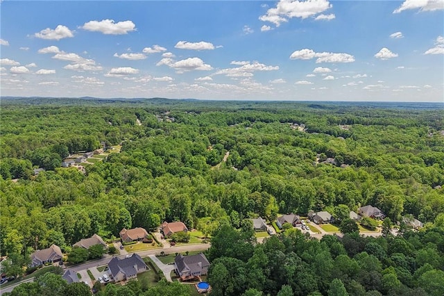 aerial view of residential area featuring a forest