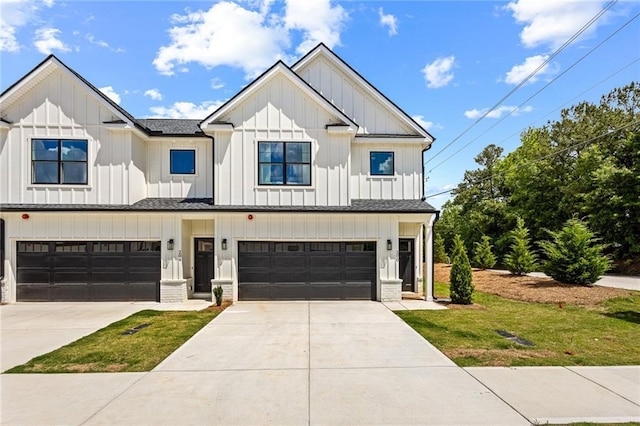 modern inspired farmhouse with board and batten siding, a garage, concrete driveway, and a front lawn