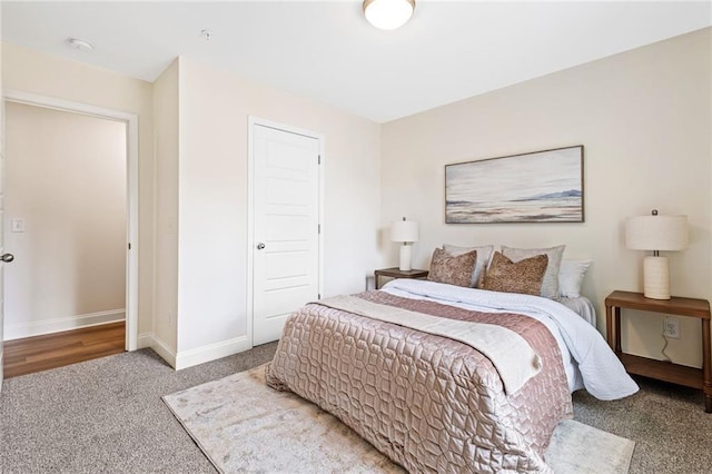 carpeted bedroom featuring baseboards