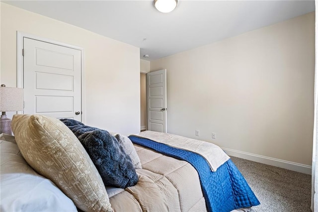 bedroom featuring carpet floors and baseboards