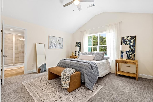bedroom featuring carpet flooring, vaulted ceiling, baseboards, ensuite bath, and a ceiling fan