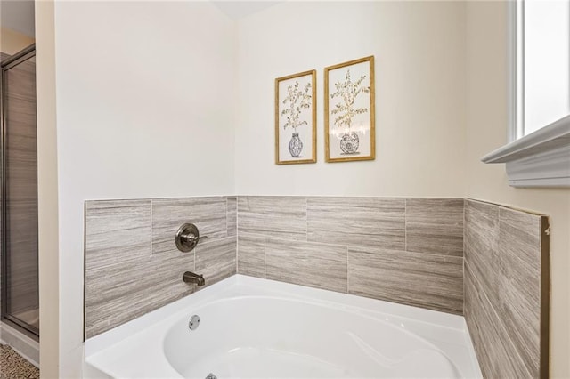 full bath with a bath and a shower stall
