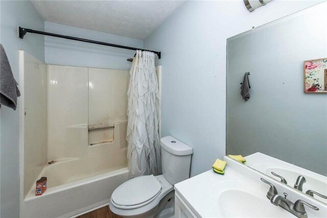 57 George Byrom Rd, Newnan, GA 30263 - bathroom with toilet, a textured ceiling, shower / bathtub combination with curtain, and vanity