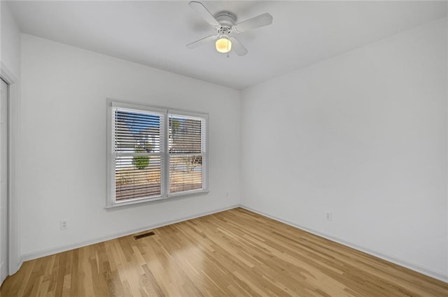 unfurnished room with ceiling fan and light wood-type flooring