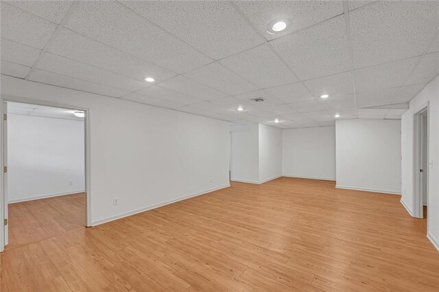 exercise area featuring wood-type flooring, a paneled ceiling, and electric panel