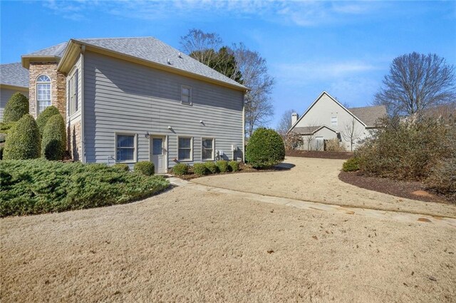 surrounding community with a water view and a lawn