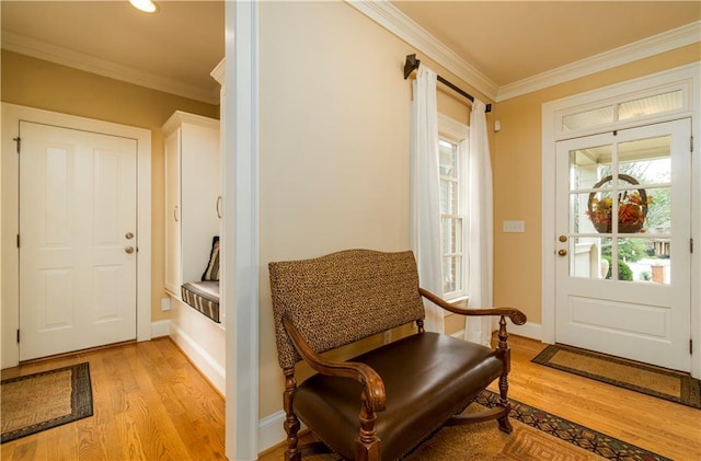 interior space featuring crown molding and light hardwood / wood-style flooring