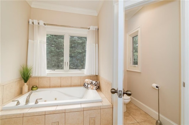 bathroom with tile patterned flooring, crown molding, tiled bath, and toilet