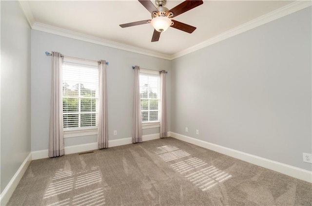 carpeted empty room with crown molding and ceiling fan