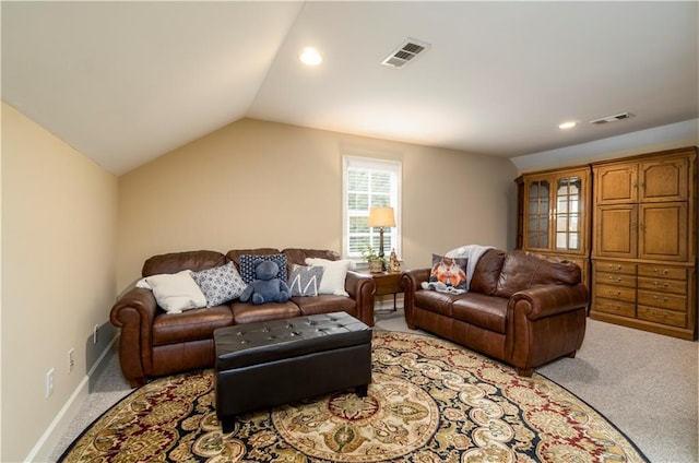 living room with vaulted ceiling and light colored carpet