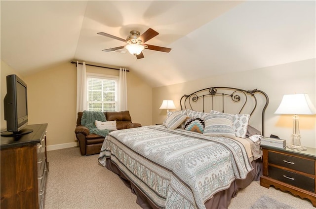 bedroom with vaulted ceiling, light colored carpet, and ceiling fan