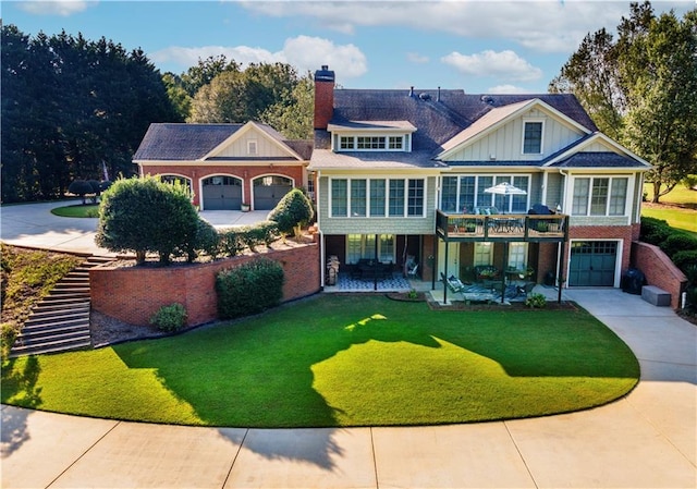 view of front of house with a garage, a patio area, and a front yard