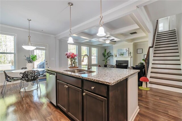 2021 Adam Acres Dr, Lawrenceville, GA 30043 - kitchen featuring a sink, ceiling fan, dark brown cabinetry, a fireplace, and stainless steel dishwasher