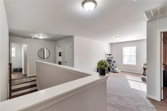 2021 Adam Acres Dr, Lawrenceville, GA 30043 - hallway featuring carpet floors, baseboards, and visible vents