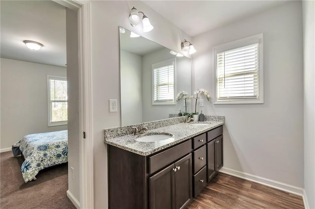 2021 Adam Acres Dr, Lawrenceville, GA 30043 - bathroom with double vanity, ensuite bathroom, baseboards, and a sink