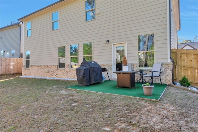 2021 Adam Acres Dr, Lawrenceville, GA 30043 - rear view of property with brick siding, fence, and a patio area