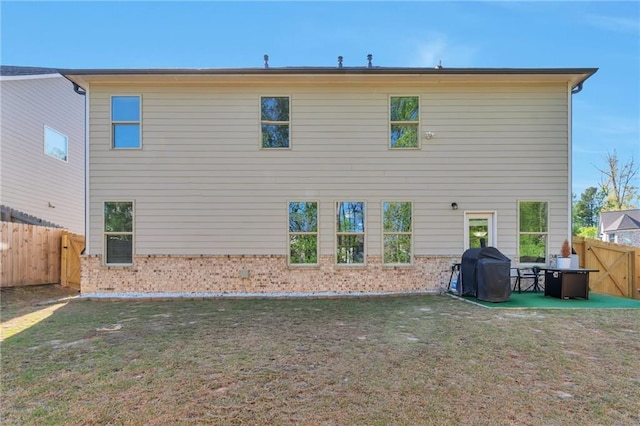 2021 Adam Acres Dr, Lawrenceville, GA 30043 - rear view of house with a lawn, a fenced backyard, a patio, and brick siding