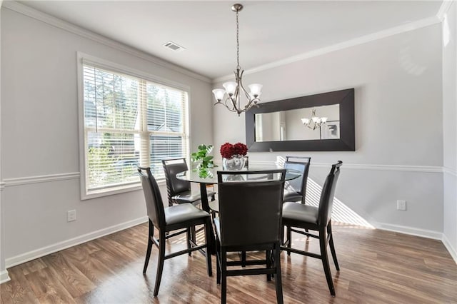 2021 Adam Acres Dr, Lawrenceville, GA 30043 - dining room with ornamental molding, visible vents, a notable chandelier, and wood finished floors
