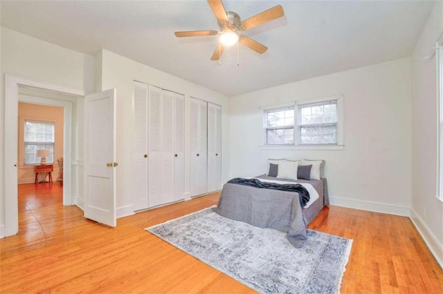 bedroom with hardwood / wood-style floors, multiple windows, and ceiling fan