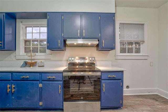 kitchen with blue cabinetry and electric range