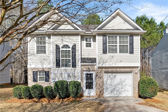 view of front of house featuring brick siding, driveway, and an attached garage