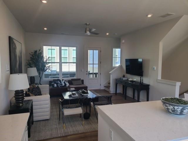 living area featuring visible vents, stairway, a wealth of natural light, and recessed lighting