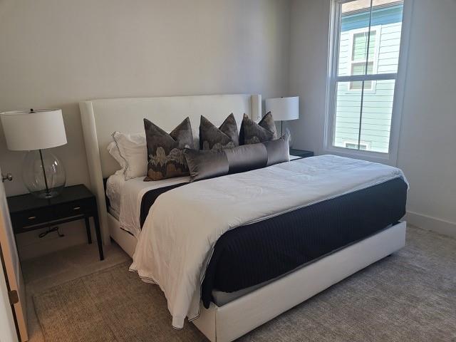 carpeted bedroom with baseboards