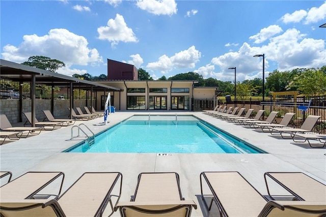 pool featuring a patio area and fence