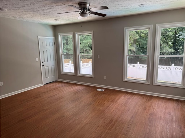 1516 Chase Ct, Riverdale, GA 30296 - unfurnished room with wood finished floors, a ceiling fan, plenty of natural light, and a textured ceiling