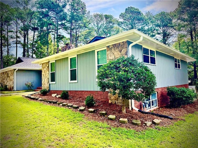 1516 Chase Ct, Riverdale, GA 30296 - view of side of home with a yard, stone siding, and board and batten siding