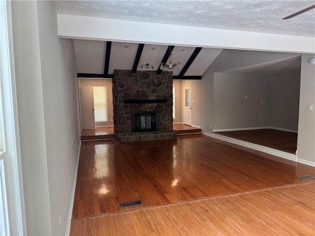 1516 Chase Ct, Riverdale, GA 30296 - unfurnished living room featuring wood finished floors and a stone fireplace