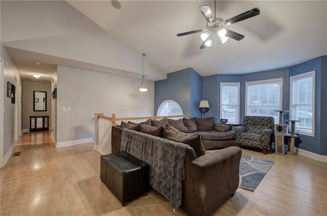 living room featuring vaulted ceiling, ceiling fan, and light wood-type flooring