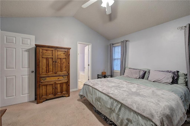 bedroom featuring ensuite bathroom, lofted ceiling, light colored carpet, a textured ceiling, and ceiling fan