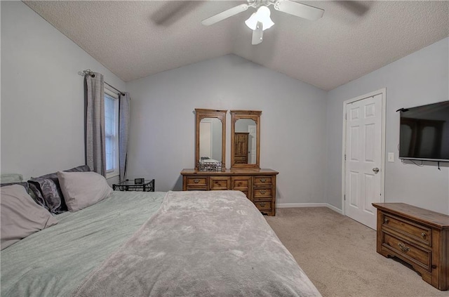 bedroom featuring light carpet, a textured ceiling, vaulted ceiling, and ceiling fan